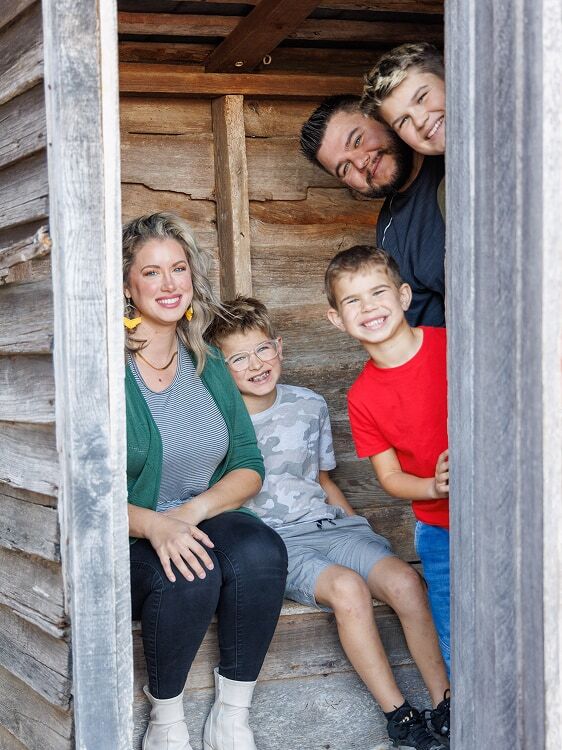 a family in an outhouse photo spot