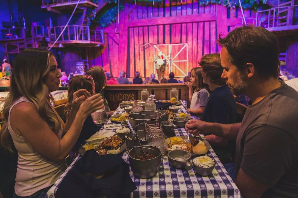 family enjoying dinner at Hatfield and McCoy Dinner Feud