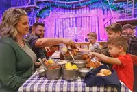 family enjoying a feast at Hatfield & McCoy Dinner Feud