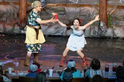 Ma Hatfield holding firework with young girl during the show